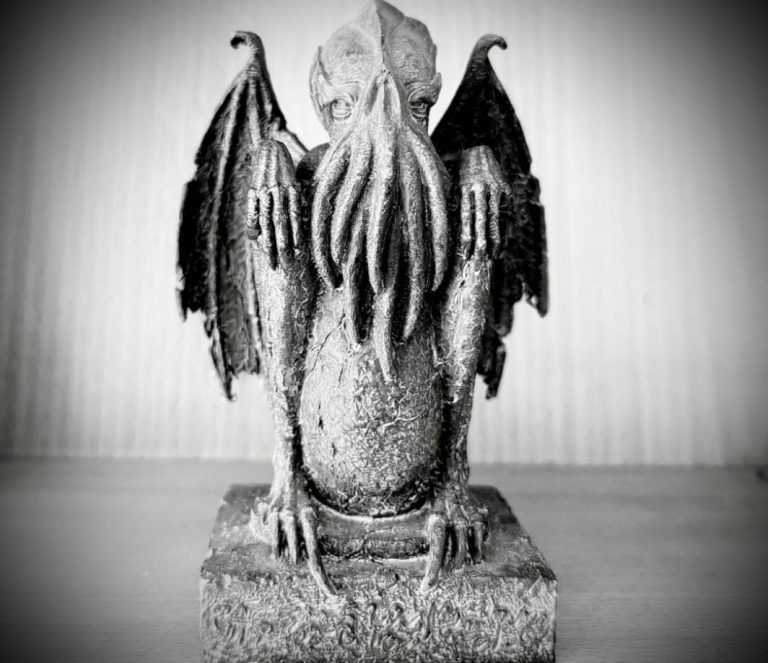 Small figurine with bat wings on a windowsill — symbol for the shadow self